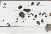<p>Cheng Ran, <em>Tide Conversations</em>, 2013, mixed media installation (stones, sea shells, fountain pen nibs, inscribed notepaper, wooden plinth and glass cover), 105 x 244 x 80 cm, detail</p>
