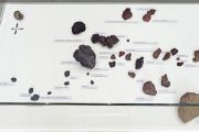 <p>Cheng Ran, <em>Tide Conversations</em>, 2013, mixed media installation (stones, sea shells, fountain pen nibs, inscribed notepaper, wooden plinth and glass cover), 105 x 244 x 80 cm, detail</p>
