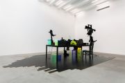 <p>Cheng Ran, <em isrender="true">The Ear Bums 2</em>, 2017, multi-media installation (IT-hardware, glass, table, cat plushie, parquet floor), 218 x 581 x 363 cm</p>

